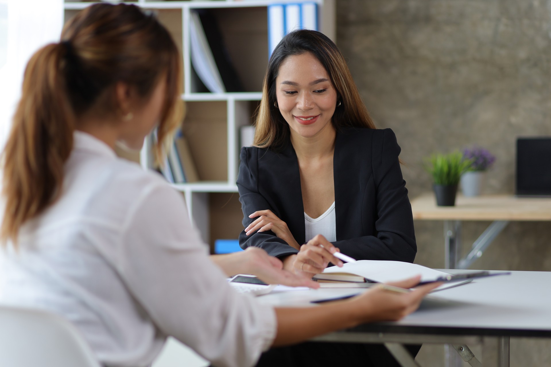 Female manager in office discussing and interviewing job applicant for new employees. Businesswomen and colleagues discussing and discussing work on business projects together.